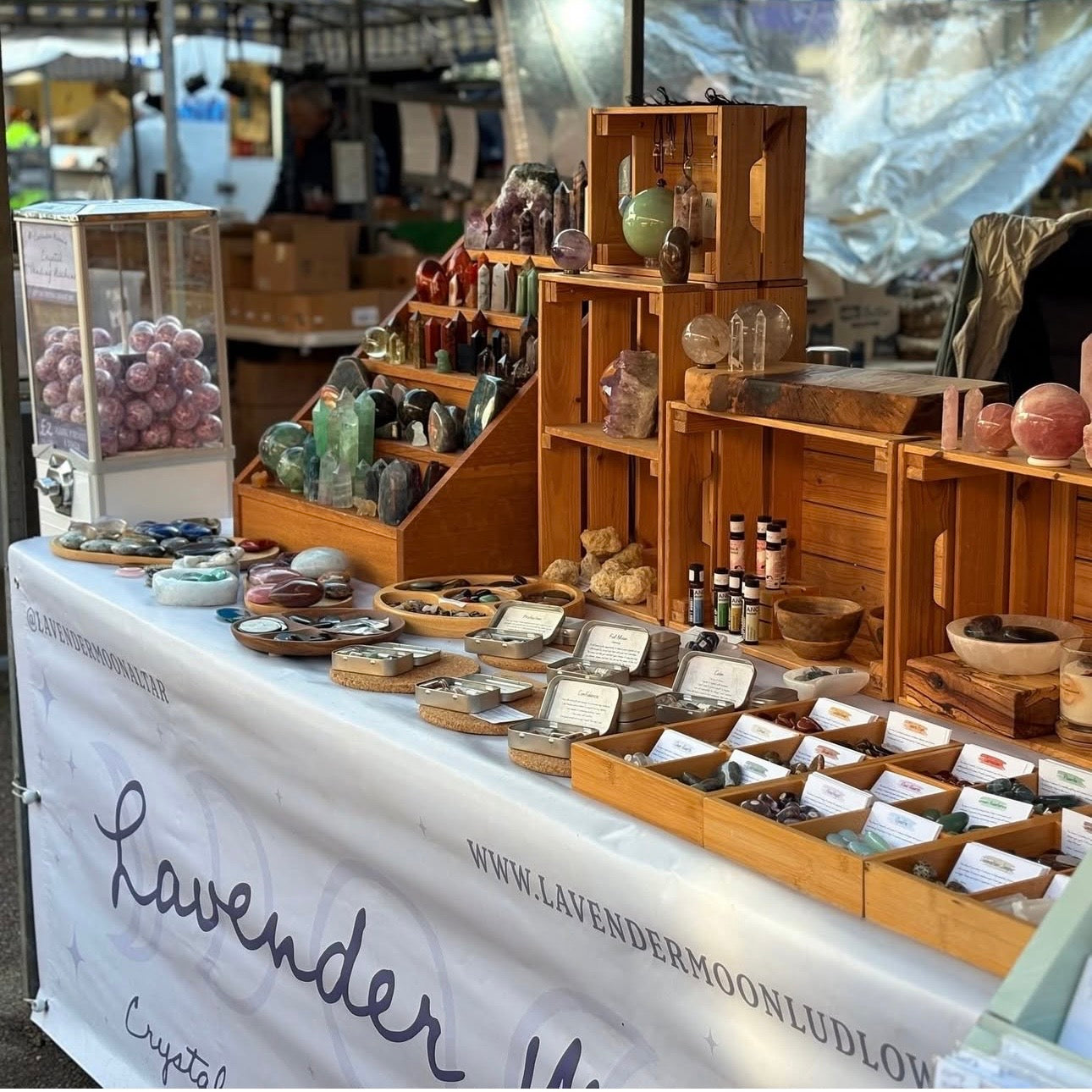 Display of crystals and products on a table with 'Lavender Moon' branding at Ludlow Market Shropshire.